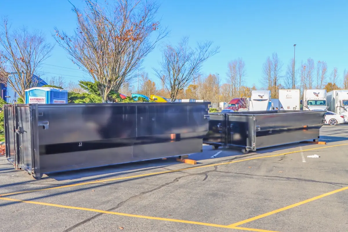 Professional dumpster rental service with roll-off container on residential driveway in Indian Hills